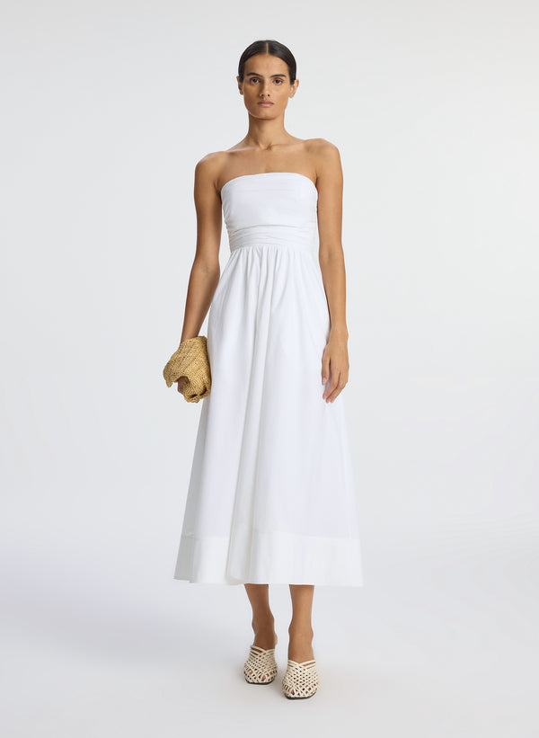 front view of woman wearing white strapless midi dress