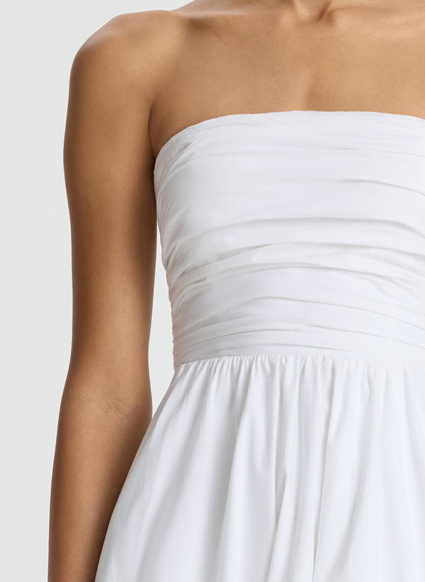 detail  view of woman wearing white strapless midi dress
