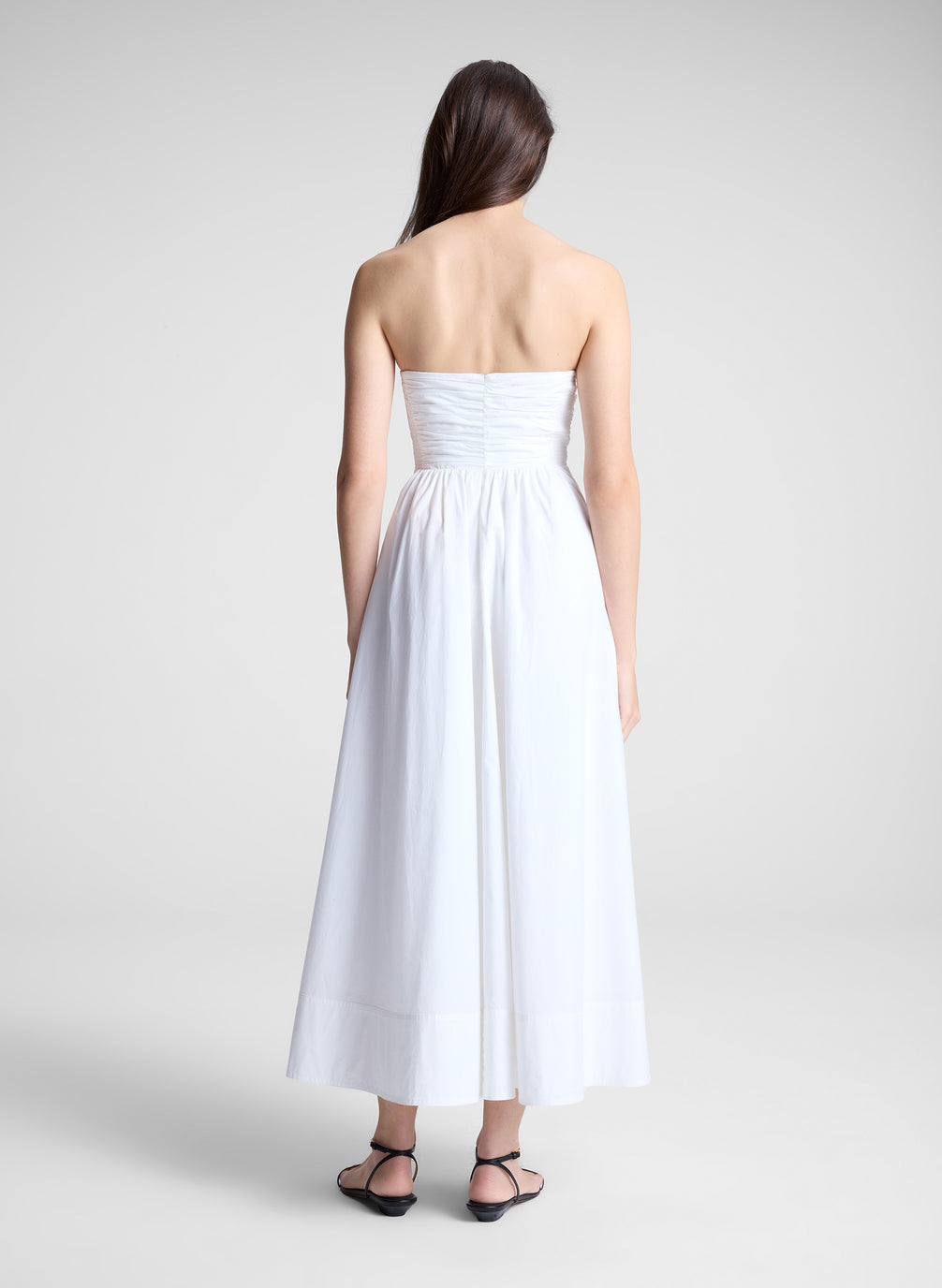 woman in white strapless midi dress