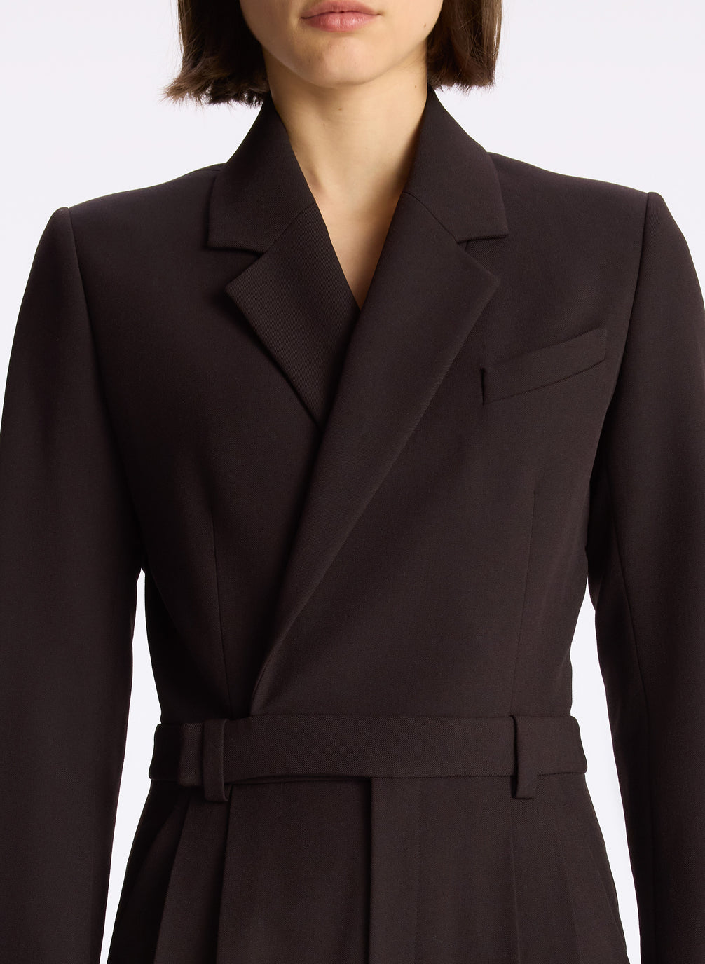 detail view of woman wearing black long sleeve jumpsuit with back cutout