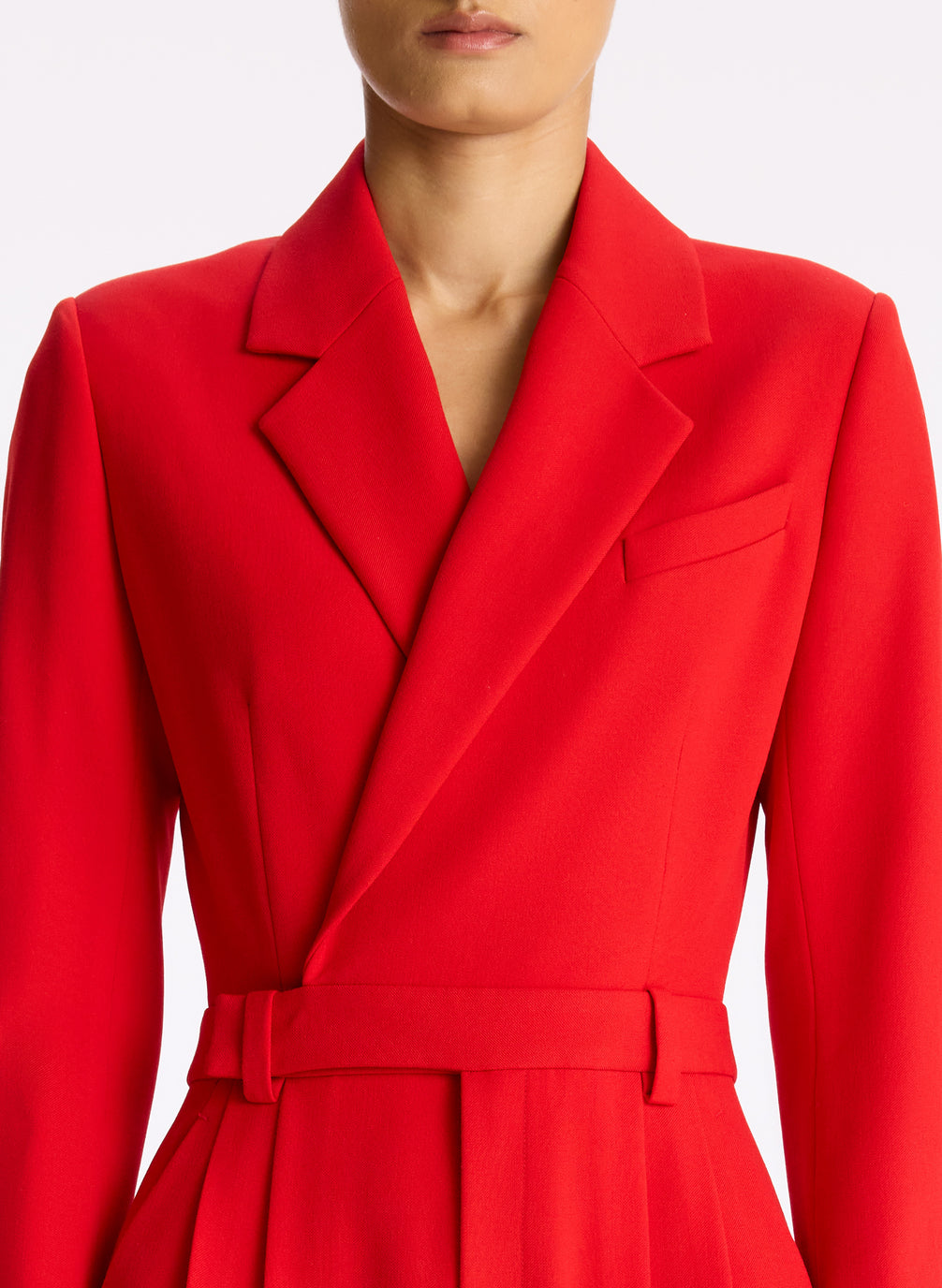 detail view of woman wearing red long sleeve jumpsuit with back cutout