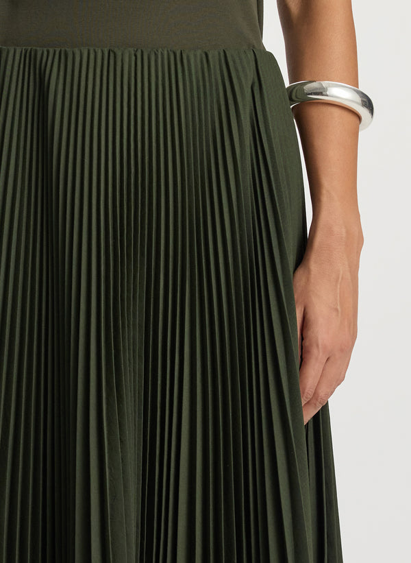 detail  view of woman wearing olive green tank with olive green pleated midi skirt