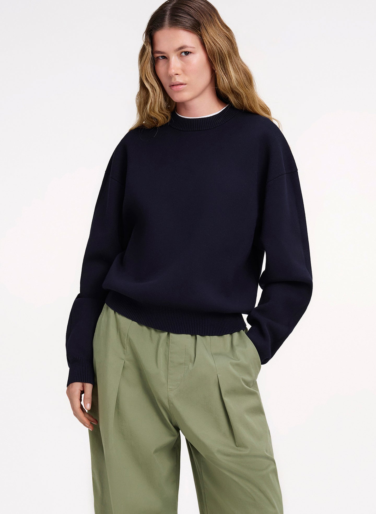 woman in navy blue sweater and green pants