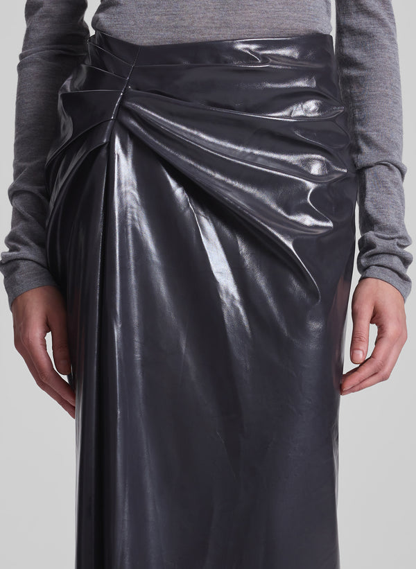 woman wearing grey turtleneck and vegan patent leather skirt