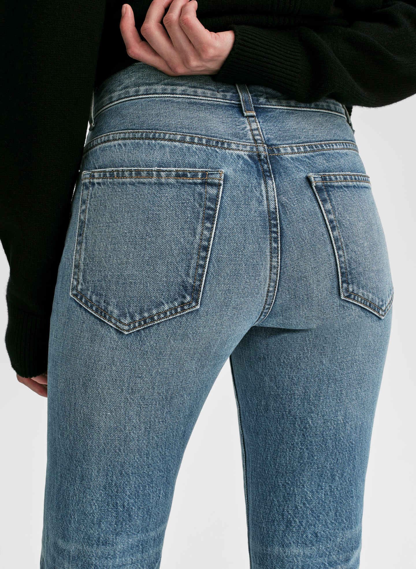 Light blue jeans worn by a person on a white background