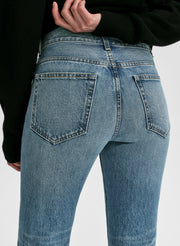 Light blue jeans worn by a person on a white background