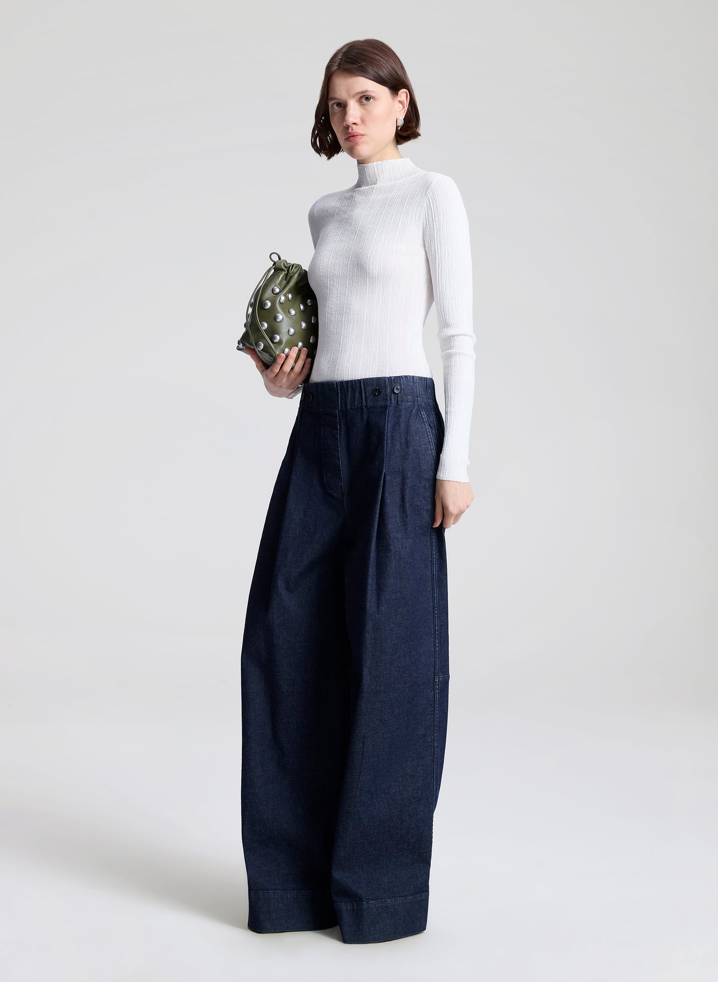 woman wearing white top and wide leg trouser jean