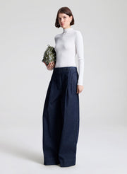 woman wearing white top and wide leg trouser jean