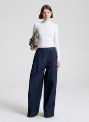 woman wearing white top and wide leg trouser jean