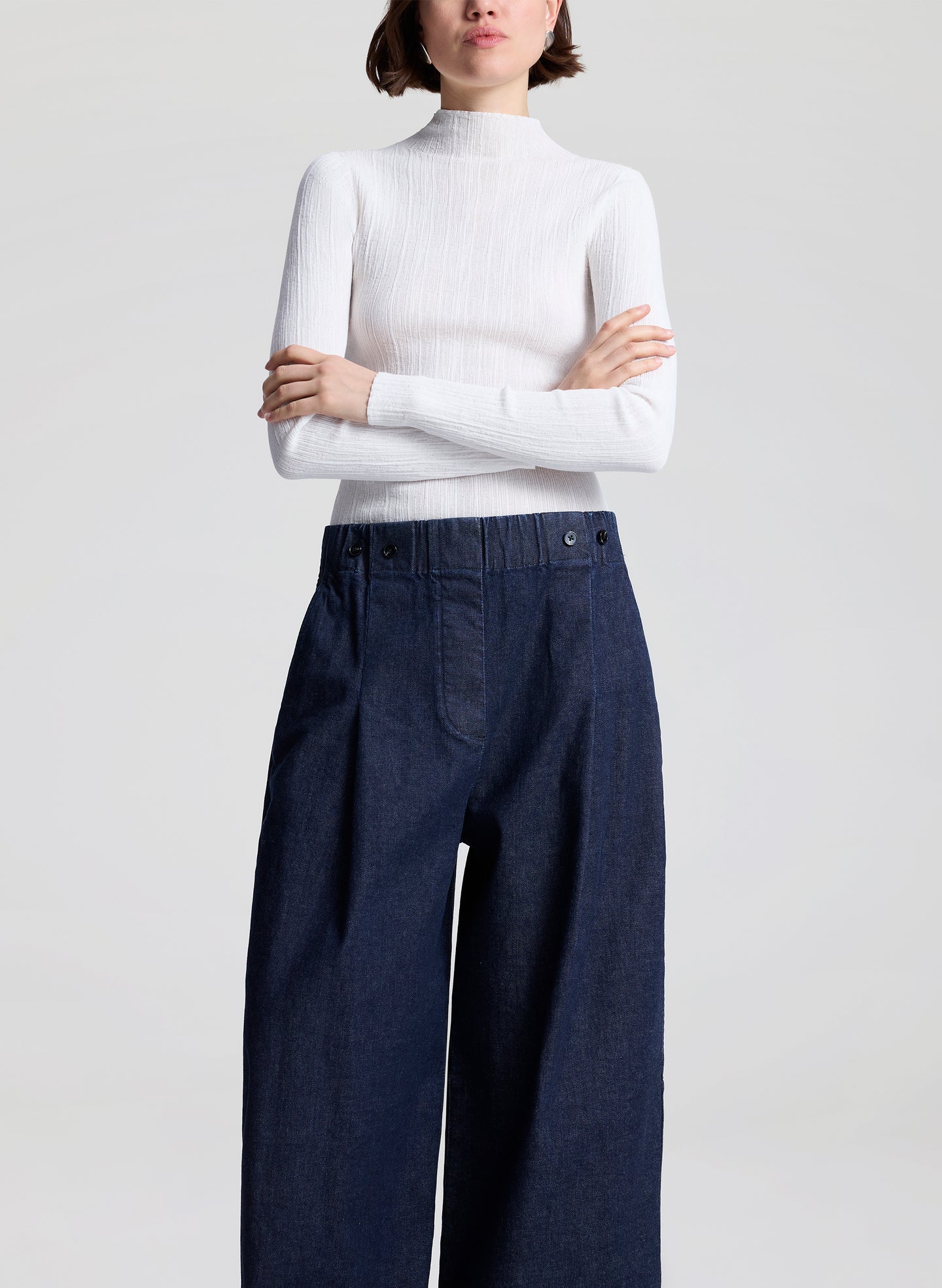 woman wearing white top and wide leg trouser jean