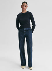 woman wearing navy blue sweater and blue jeans