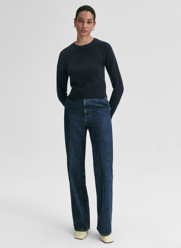 woman wearing navy blue sweater and blue jeans