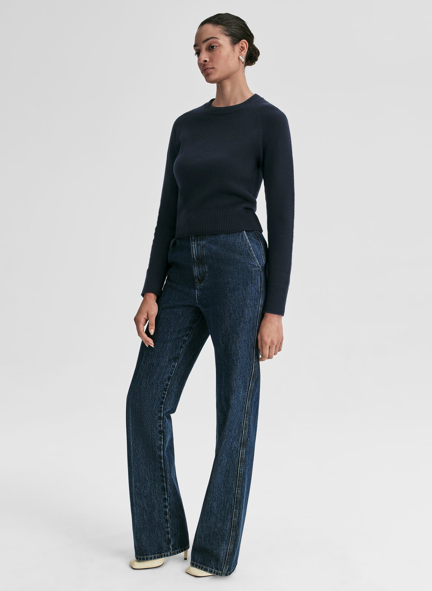 woman wearing navy blue sweater and blue jeans