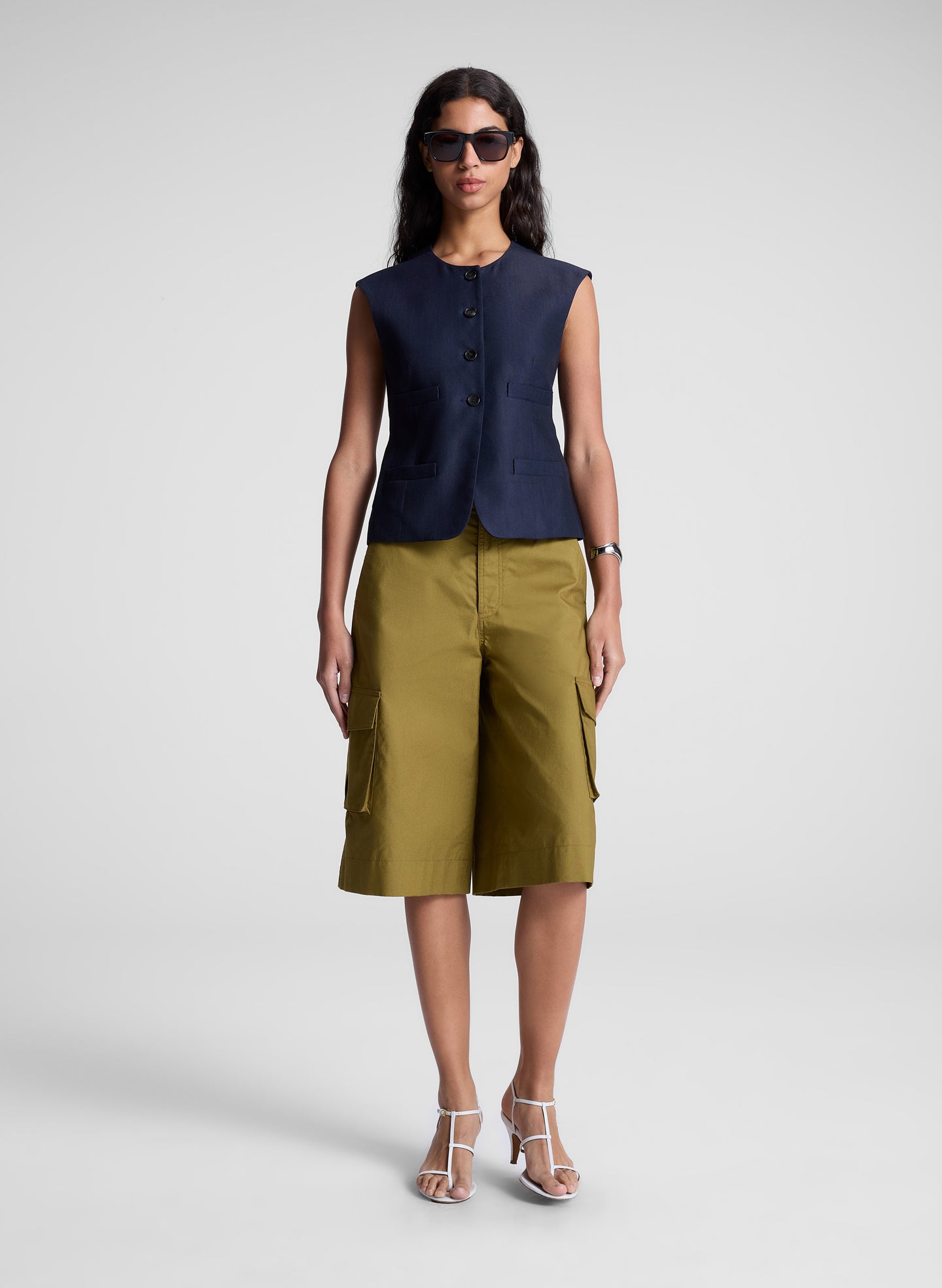 woman wearing blue vest and brown shorts