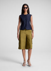 woman wearing blue vest and brown shorts