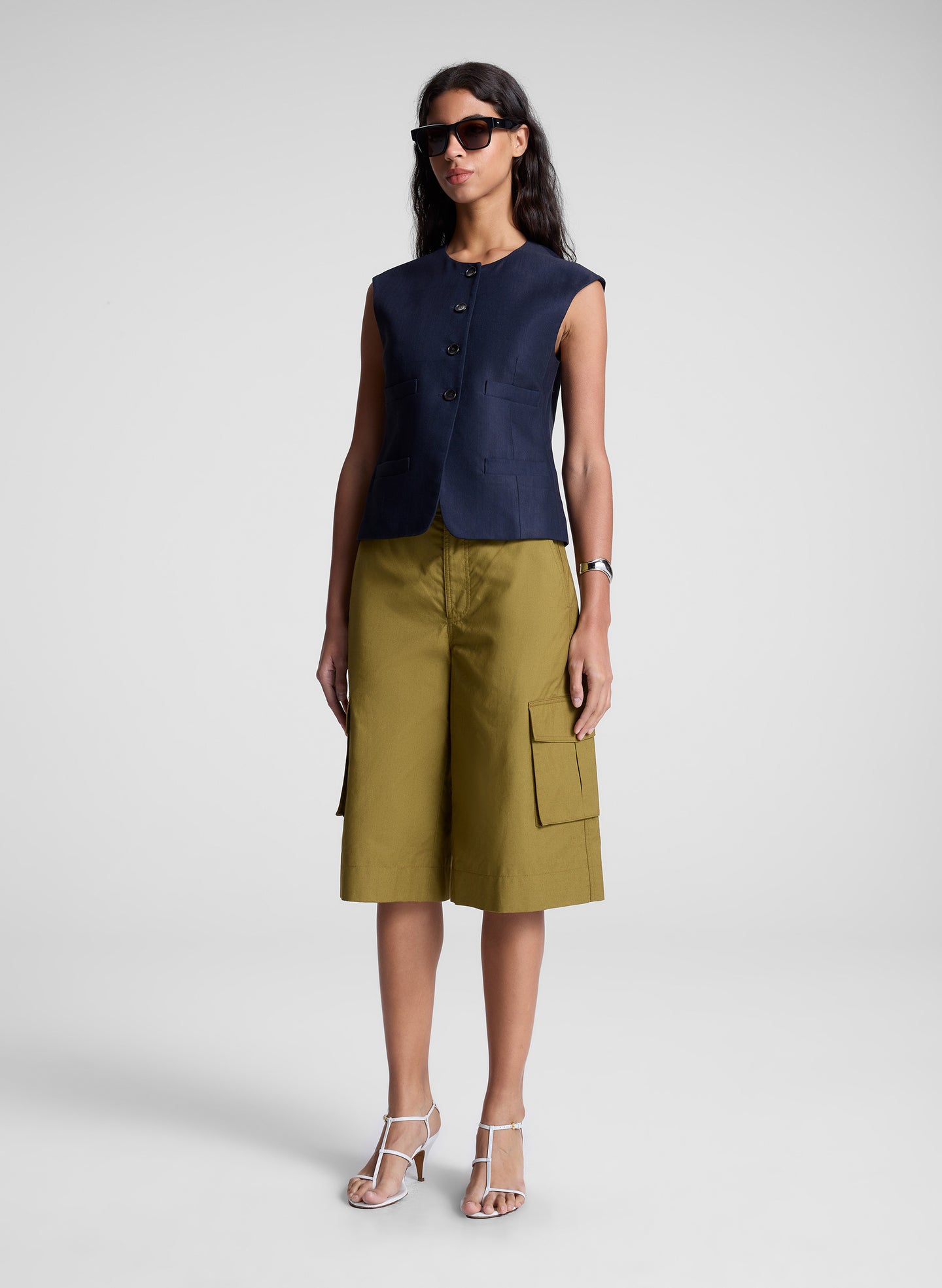 woman wearing blue vest and brown shorts