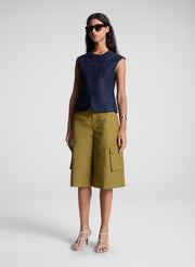 woman wearing blue vest and brown shorts