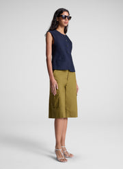 woman wearing blue vest and brown shorts