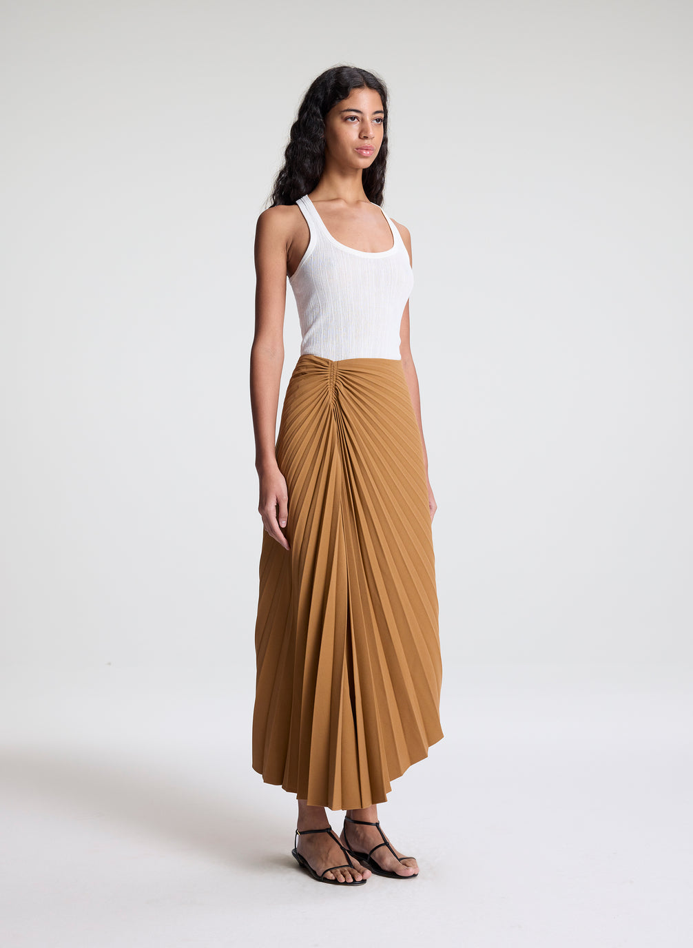 woman wearing khaki pleated midi skirt