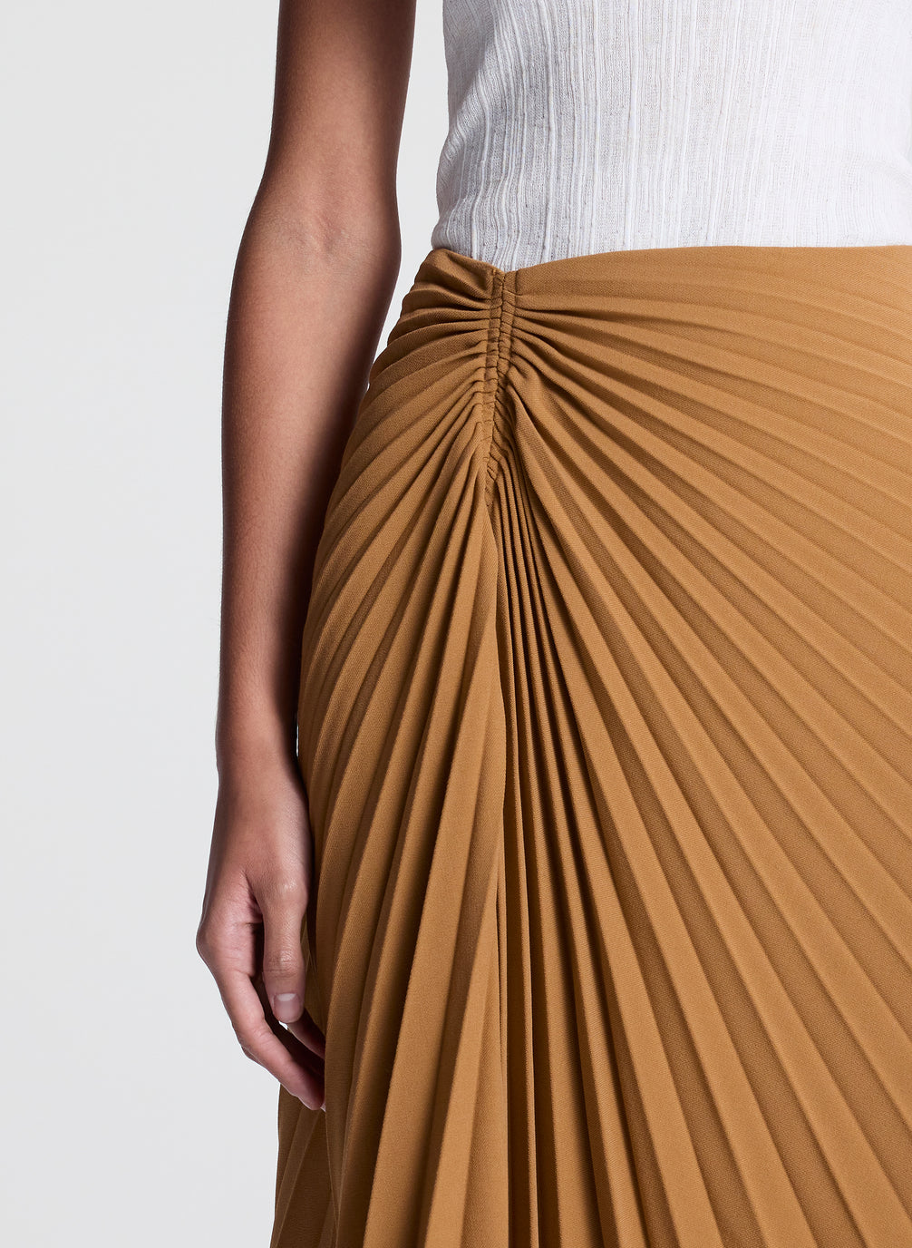 woman wearing khaki pleated midi skirt