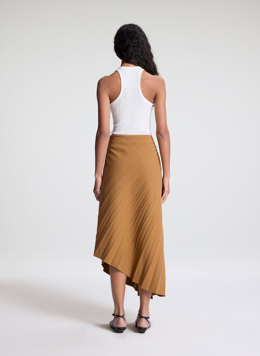 woman wearing khaki pleated midi skirt