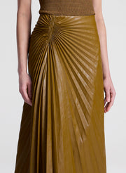 woman wearing brown top and brown pleated vegan leather skirt