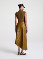 woman wearing brown top and brown pleated vegan leather skirt