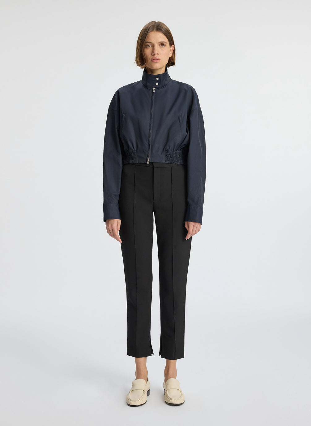 front view  view of woman in navy blue jacket and black ankle pants