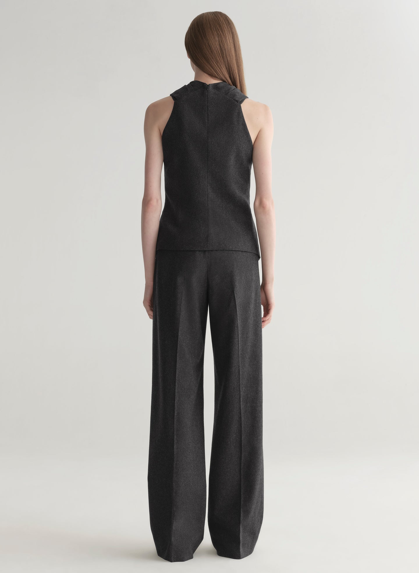 woman wearing a dark grey top and matching pants 