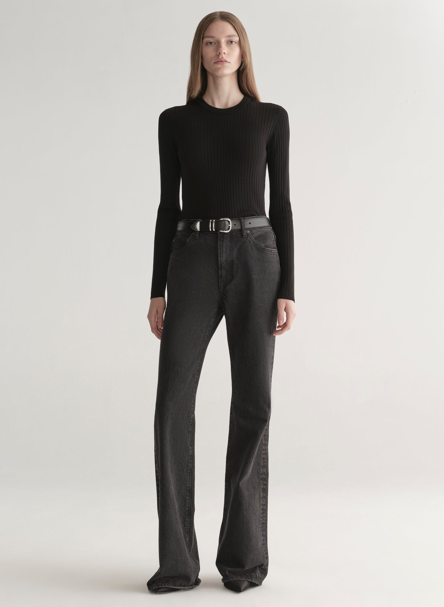 woman wearing black top and black denim jeans