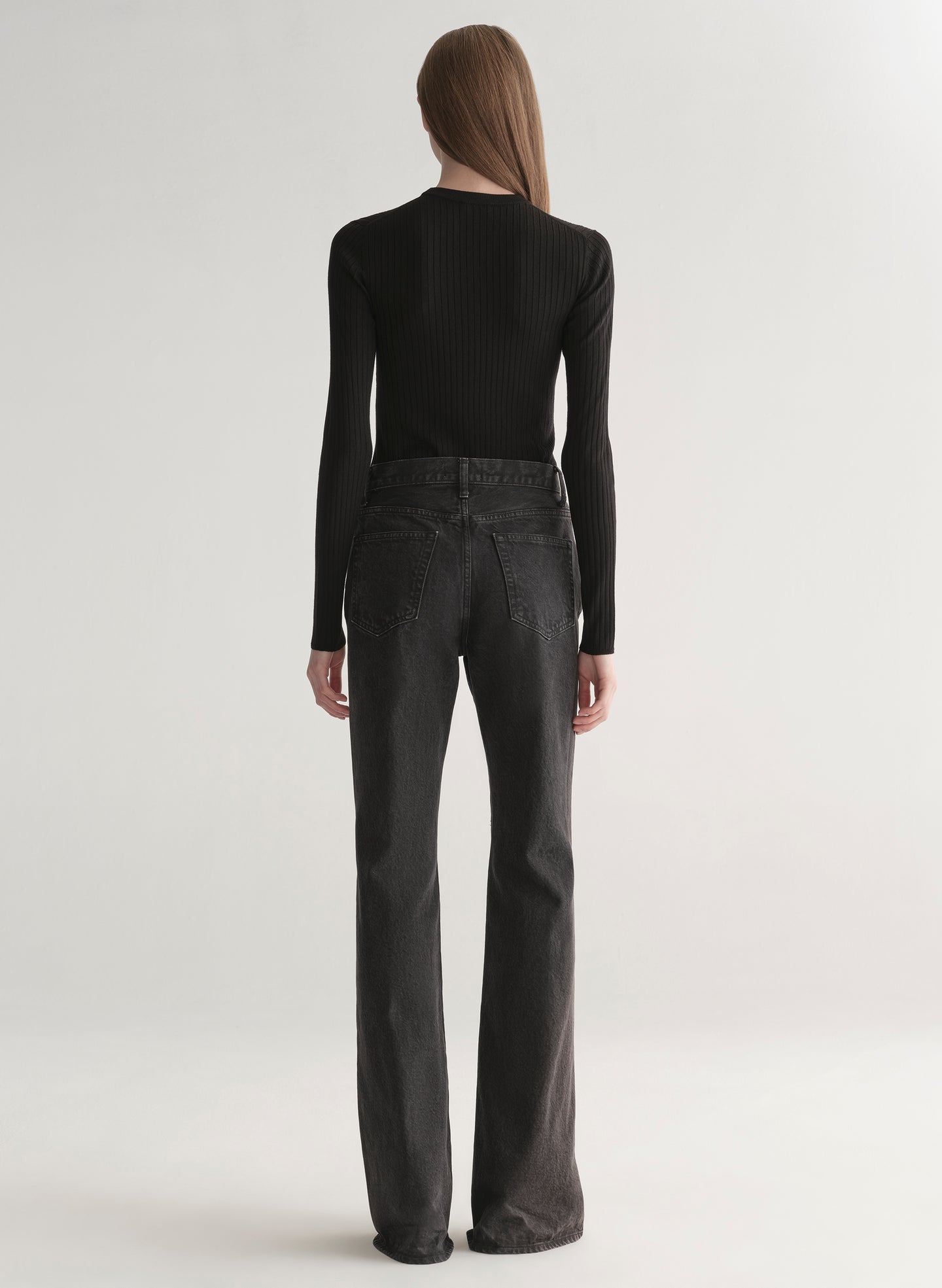 woman wearing black top and black denim jeans