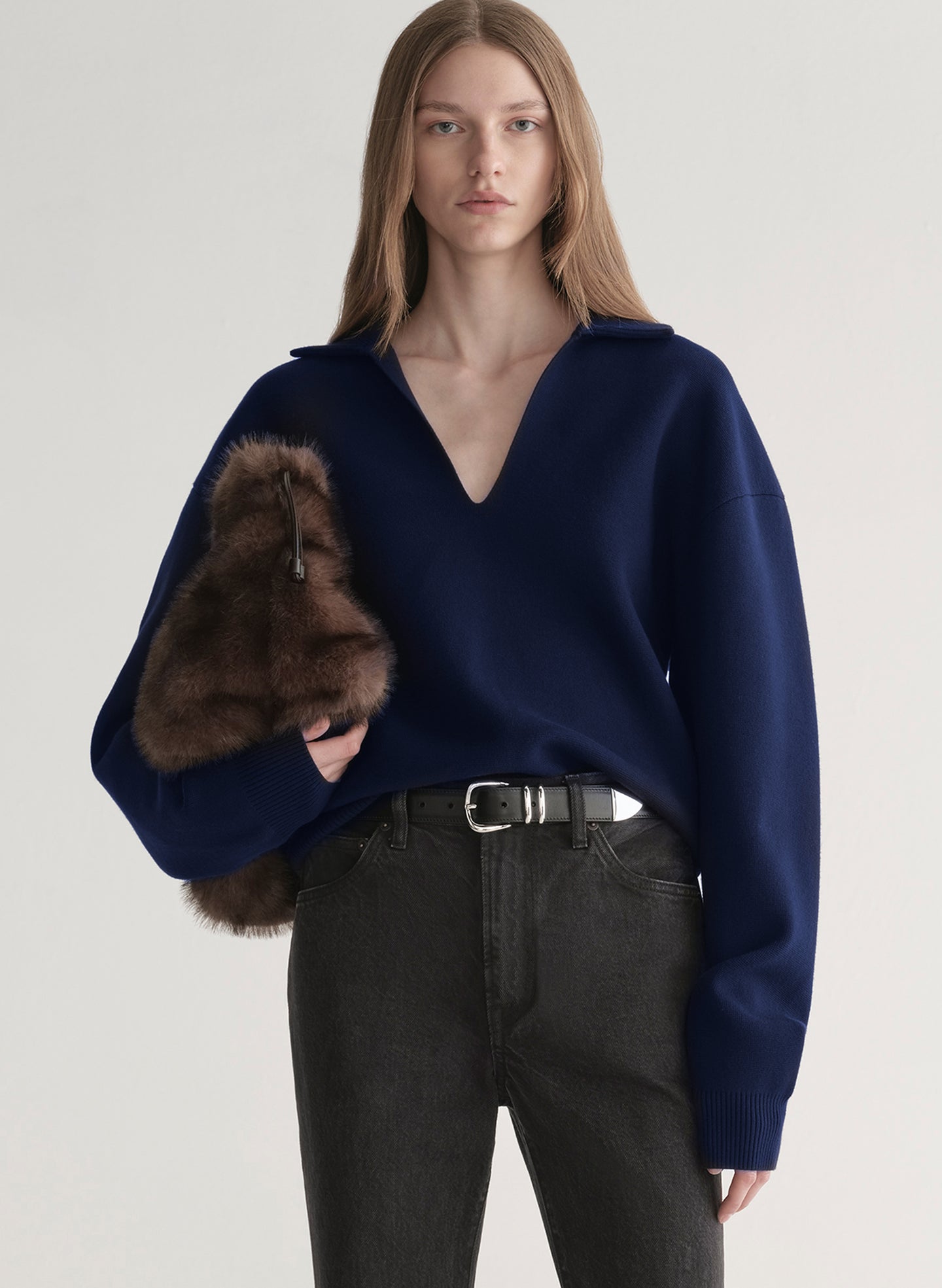 woman wearing navy blue sweater and black denim jeans