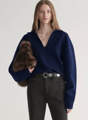 woman wearing navy blue sweater and black denim jeans