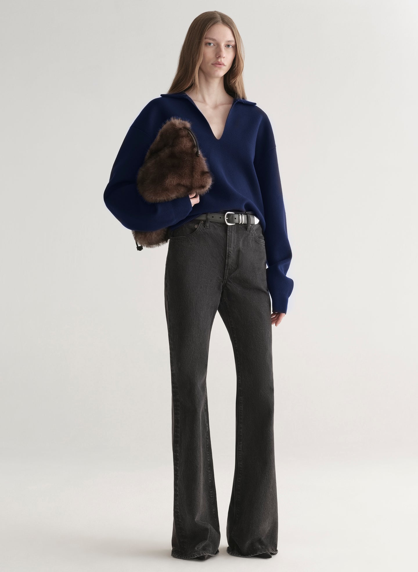 woman wearing navy blue sweater and black denim jeans