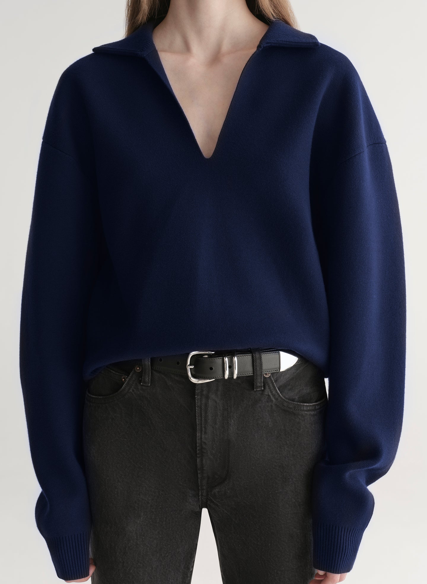 woman wearing navy blue sweater and black denim jeans