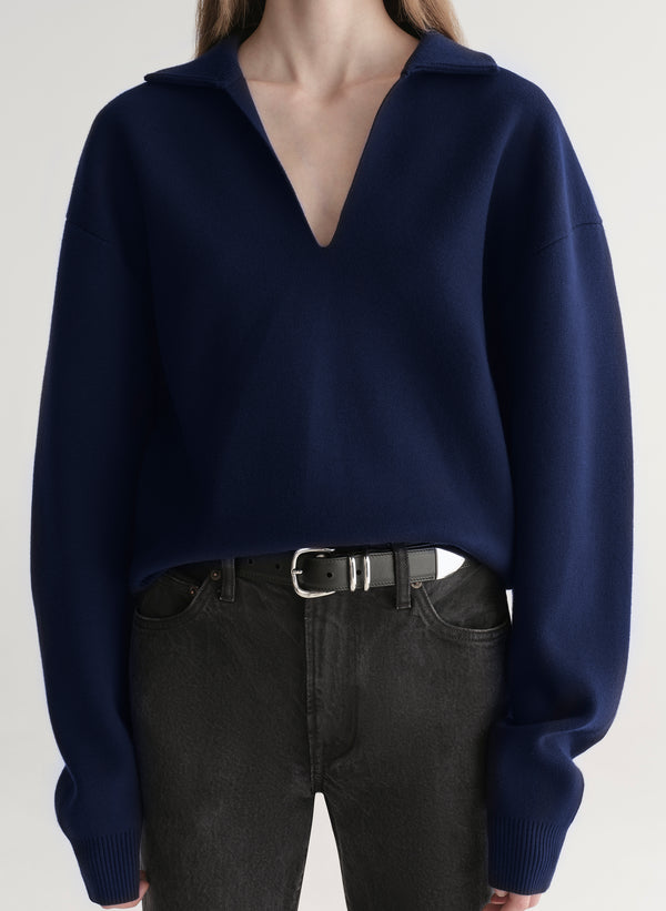 woman wearing navy blue sweater and black denim jeans