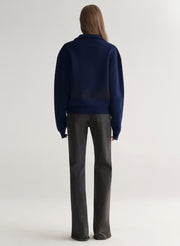 woman wearing navy blue sweater and black denim jeans