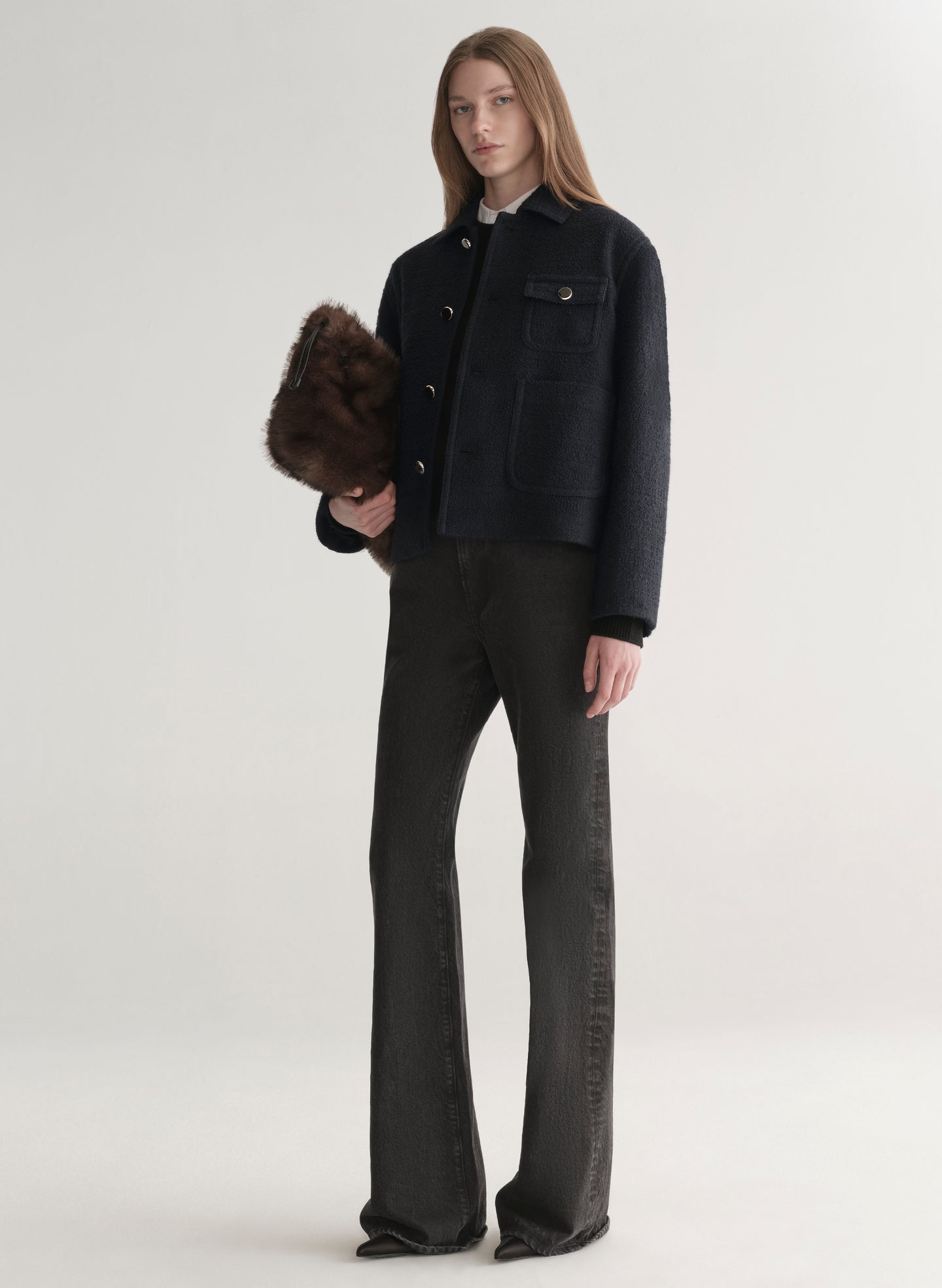 woman wearing deep navy blue jacket with white shirt and black denim jeans