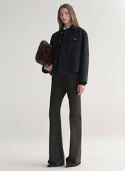 woman wearing deep navy blue jacket with white shirt and black denim jeans