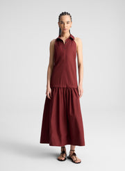 woman wearing burgundy collared drop waist midi dress