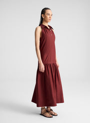 woman wearing burgundy collared drop waist midi dress