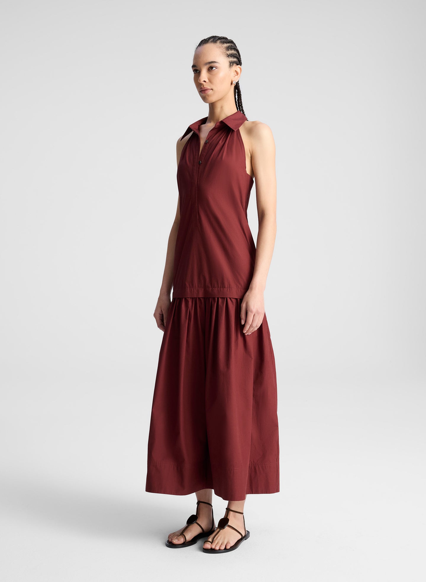woman wearing burgundy collared drop waist midi dress