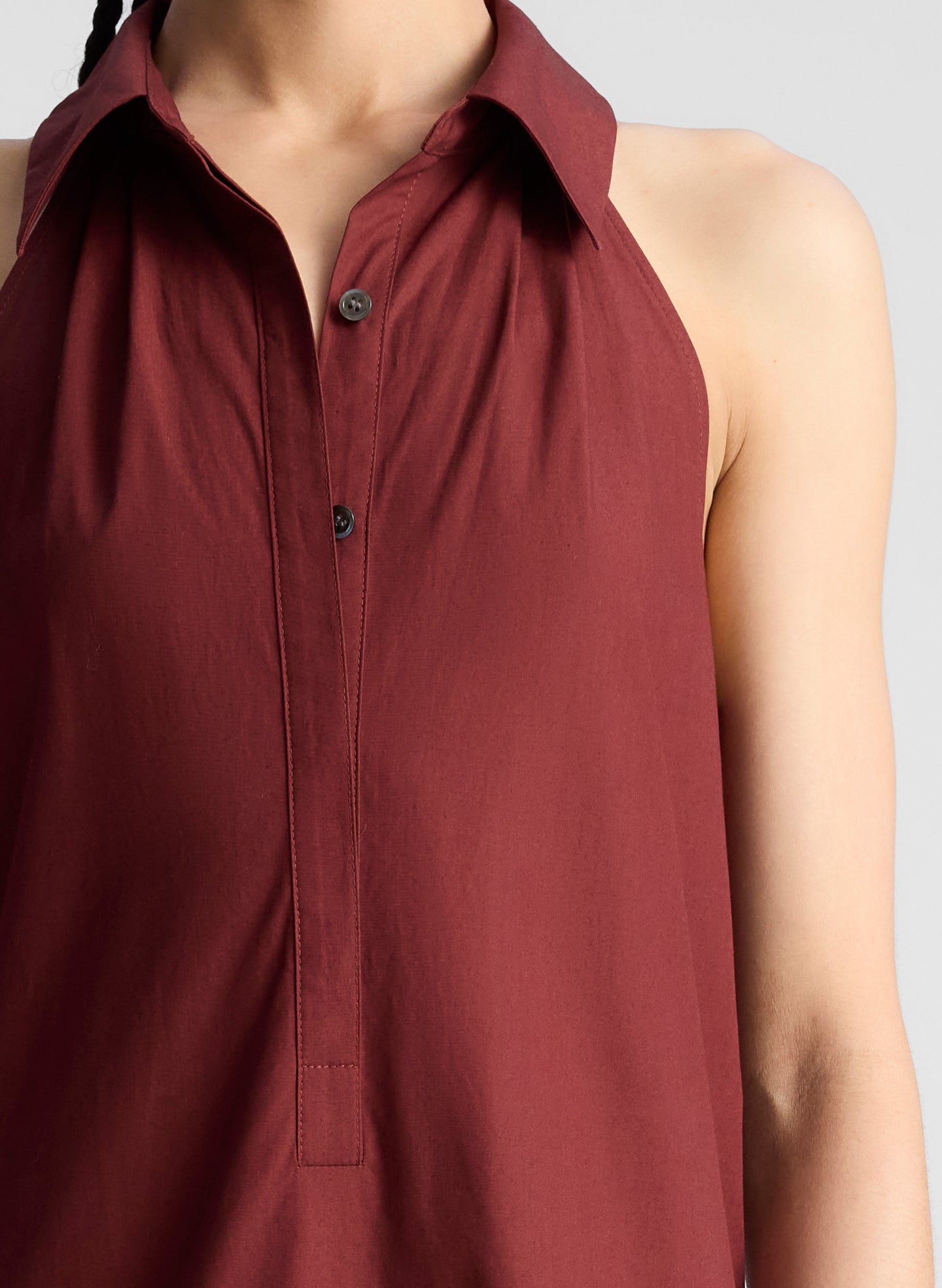 woman wearing burgundy collared drop waist midi dress