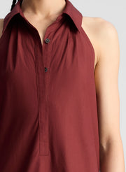 woman wearing burgundy collared drop waist midi dress