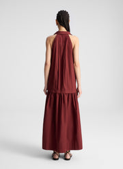 woman wearing burgundy collared drop waist midi dress