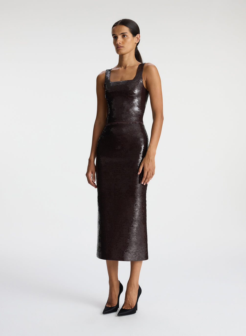 side view of woman wearing brown sequin tank top with matching brown sequin skirt