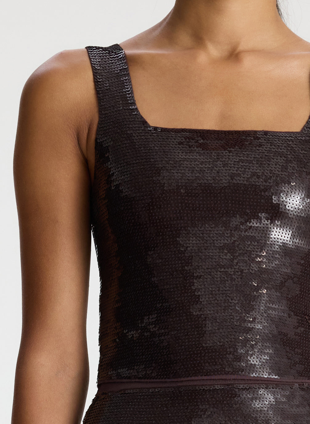 detail view of woman wearing brown sequin tank top with matching brown sequin skirt