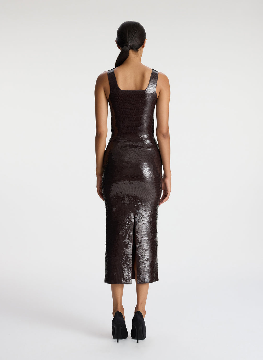 back view of woman wearing brown sequin tank top with matching brown sequin skirt