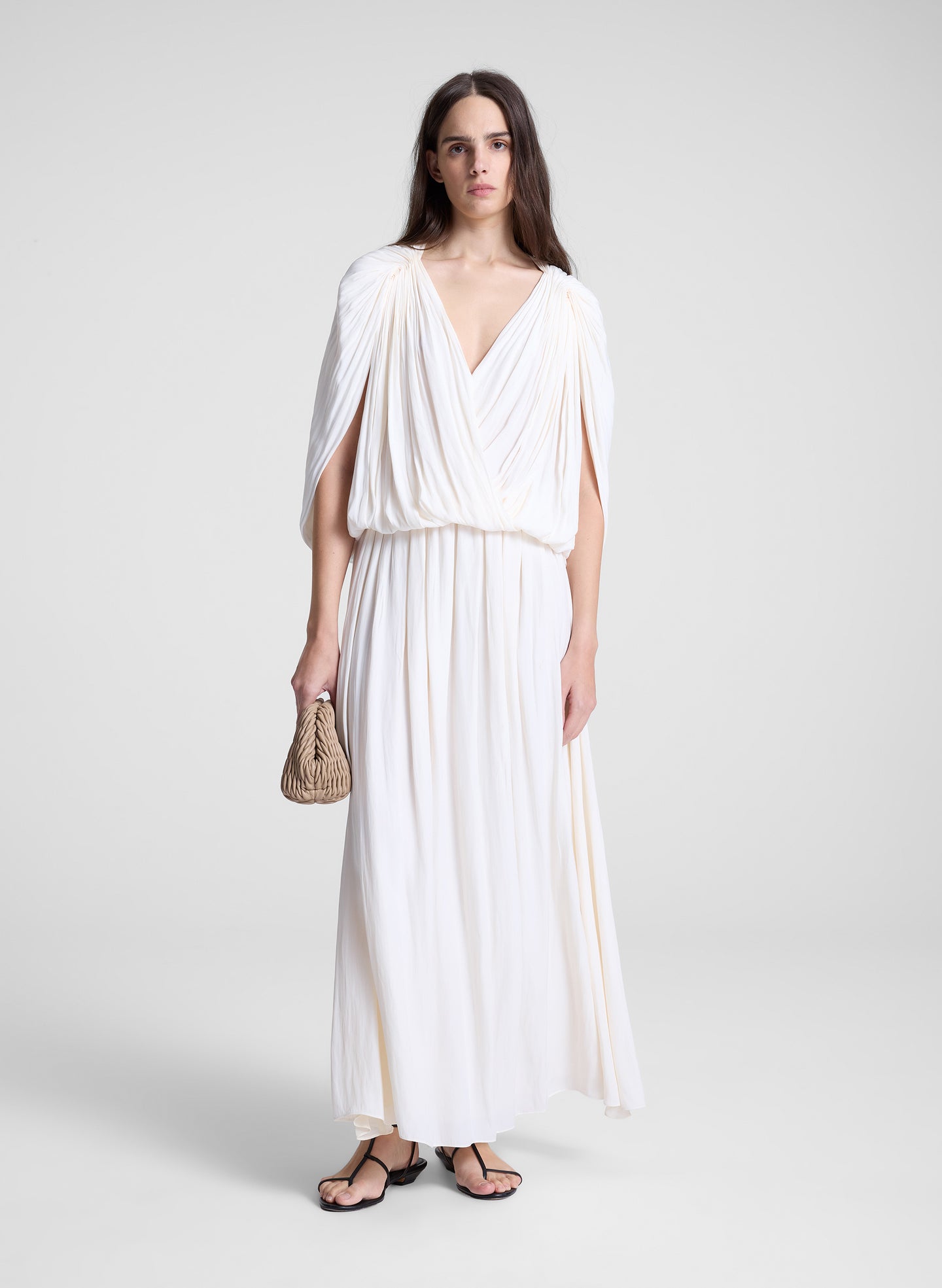 woman wearing white draped top and matching maxi skirt
