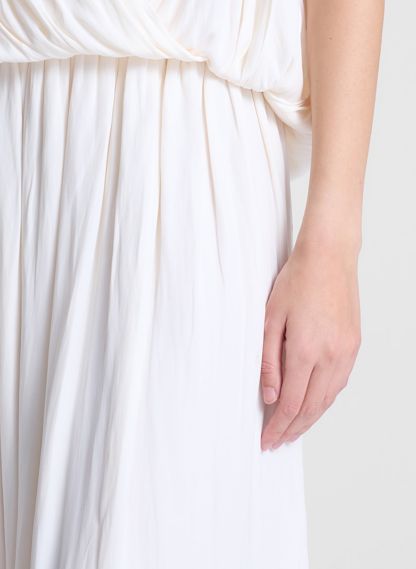 woman wearing white draped top and matching maxi skirt